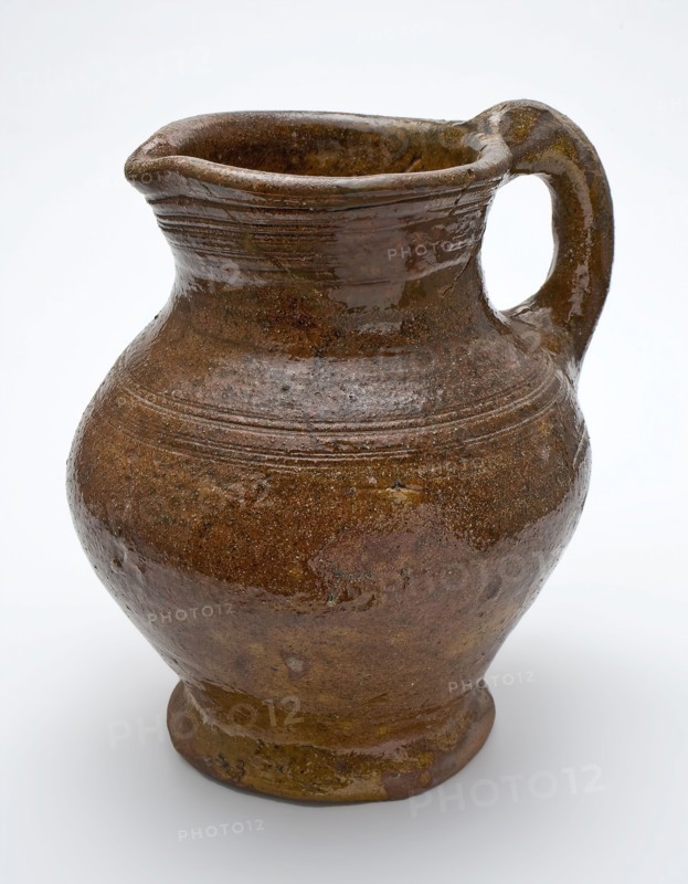 Red pottery jug with convex belly, ear and shank, rings around the neck, jug holder soil find ceramic earthenware glaze lead
