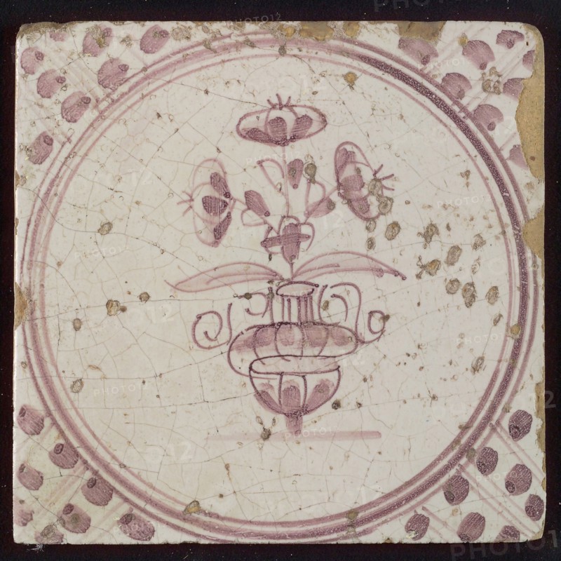 White tile with purple small flowerpot in circle frame with meanders, wall tile tile sculpture ceramic earthenware glaze, baked