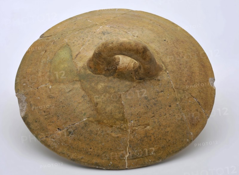 Yellow round lid with ear, pottery, white shard, lid closure soil find ceramic earthenware glaze lead glaze, hand-turned glazed