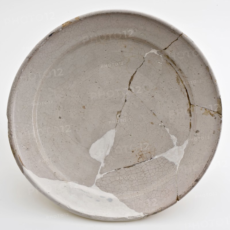 White faience plate on stand, plate crockery holder soil find ceramic earthenware glaze tinglaze, hand-turned baked glazed fried