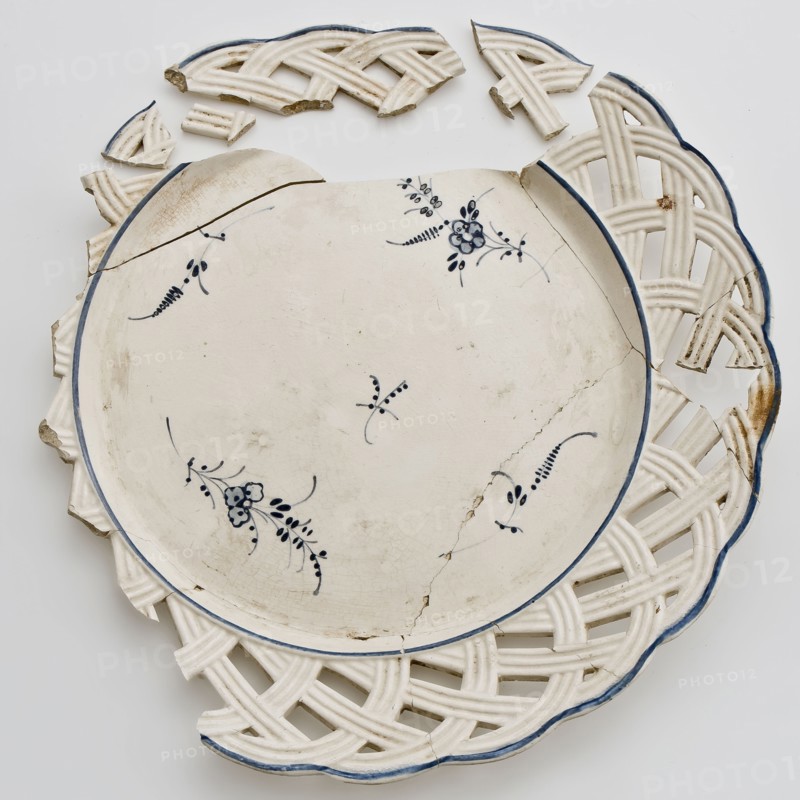 Fragments plate, lace border with wickerwork, blue spreading flowers in the mirror, plate dishware holder earthenware