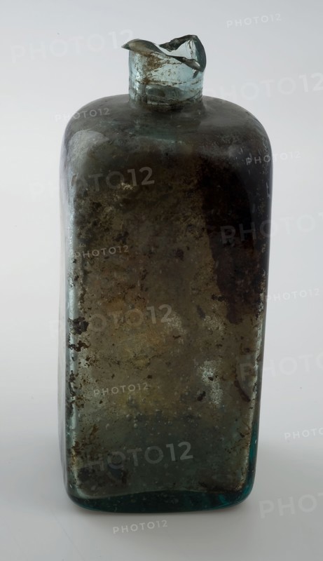Square (medicine?) Bottle with round shoulders and straight neck, medicine bottle? bottle holder soil find glass, free blown