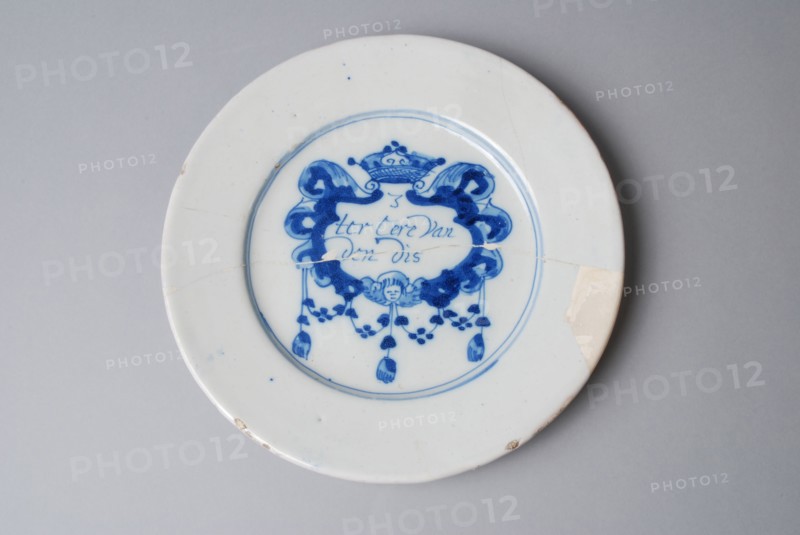 Faience plate on stand surface, with spell in modified cartouche in blue on white ground, plate dish crockery holder soil find