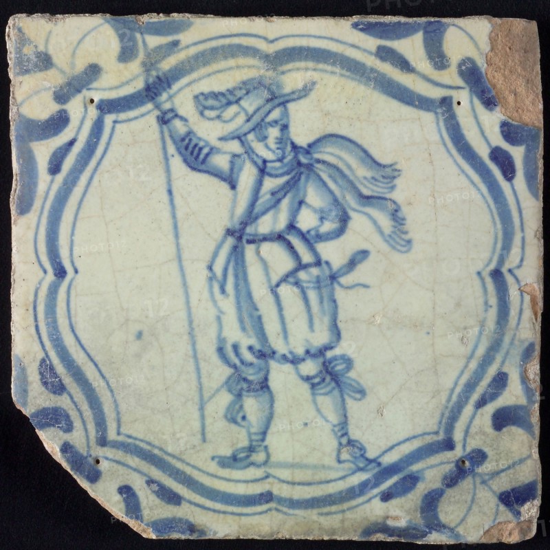 White tile with blue warrior in accolade-shaped frame; corner motif wing leaf, wall tile tile sculpture ceramic earthenware