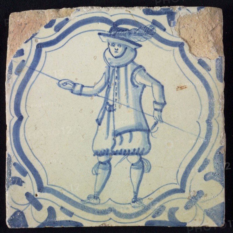 White tile with blue warrior in accolade-shaped frame; corner motif wing leaf, wall tile tile sculpture ceramic earthenware
