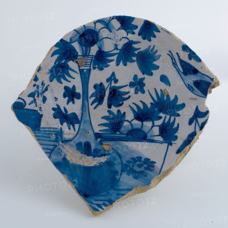 Fragment majolica plate on stand, decorated with flowers in vase, in blue on white ground, plate dish crockery holder soil find