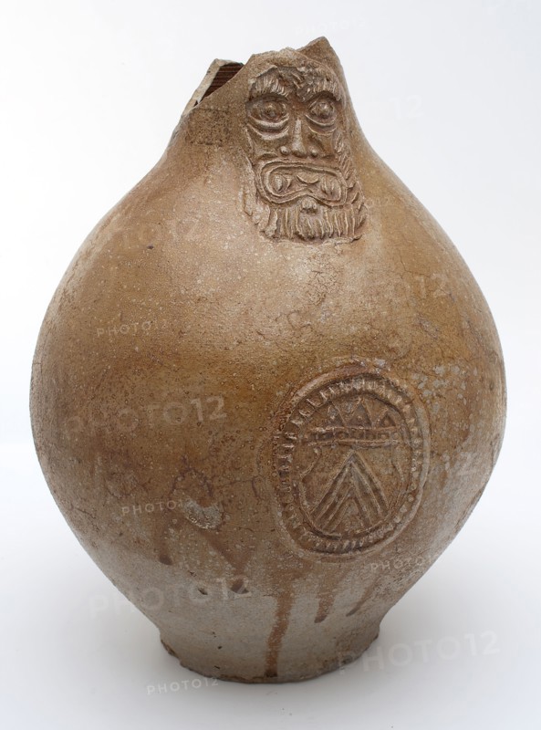 Light brown Bartmann jug, also called Bellarmine jug, under mask oval in which coat of arms, Bartmann jug jug crockery holder