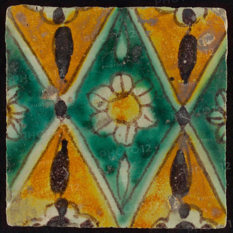 Floor tile, brown draft, green and yellow on white ground, central green oblique glass in which white flower with yellow heart