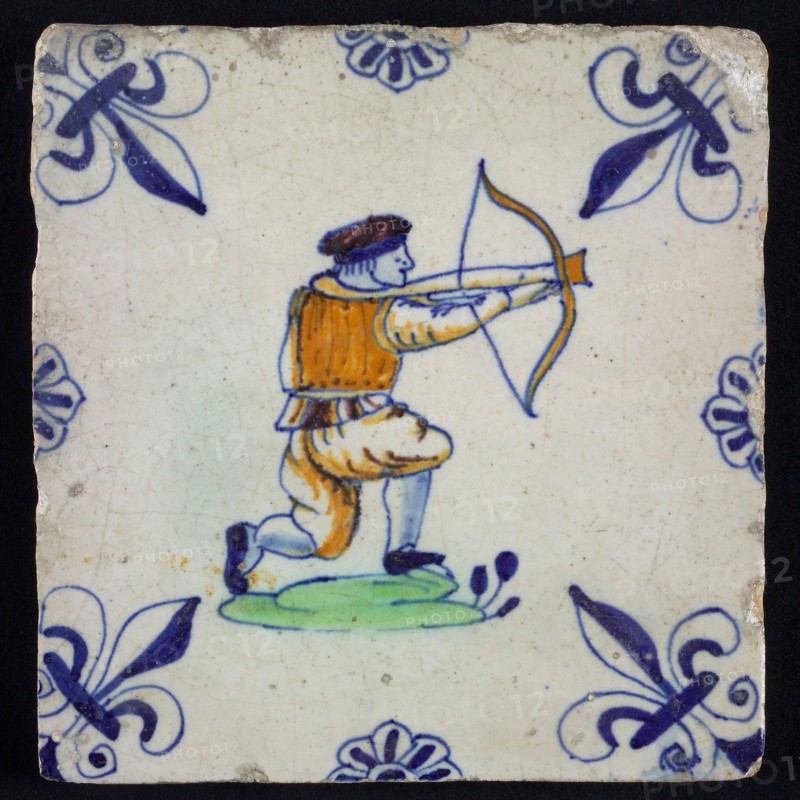 White tile with kneeling archer in yellow, green and blue, corner pattern french lily in blue and rim decoration of rosettes