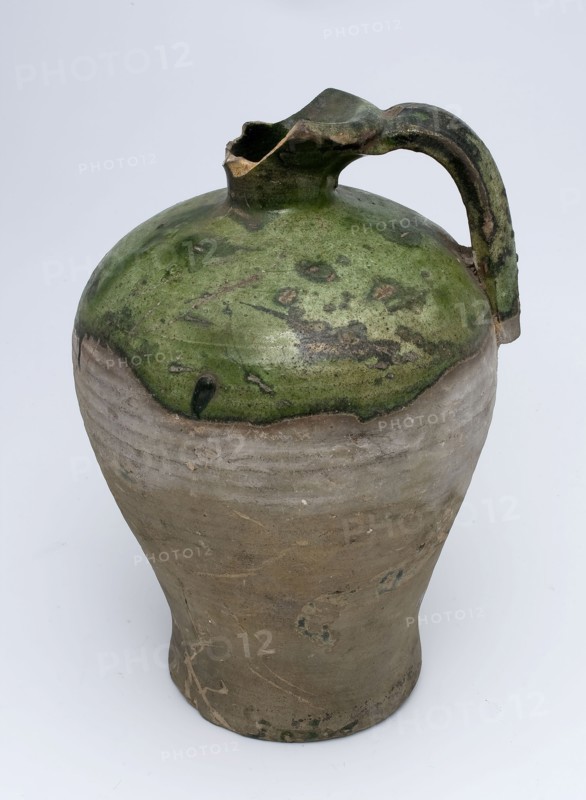 Partially green glazed gray jug with ear, narrow and protruding neck, jug holder kitchen utensils earthenware ceramics