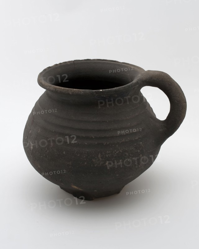 Dark gray earthenware cooking jug with sausage ear, on six fins, rotating on shoulder, cooking jug be found in the earthenware