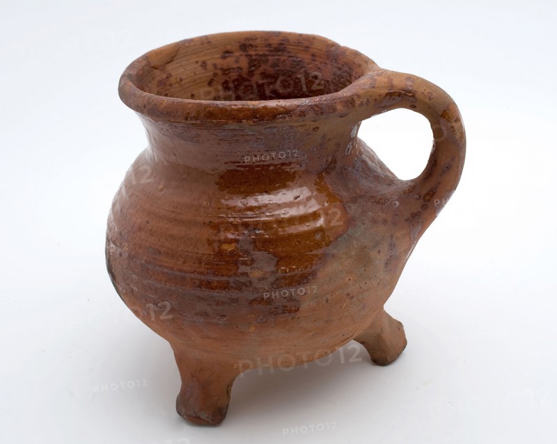 Pottery cooking jug, grape-model, red shard, sparingly glazed, vertical sausage ear, on three legs, cooking jug