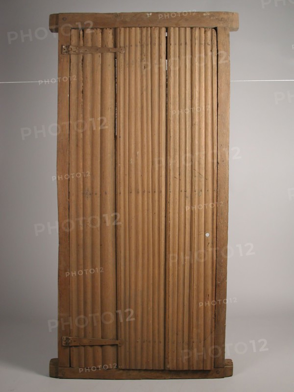 Room door in frame, door frame building part wood oak iron in frame, sawn planed nailed Room door curved up