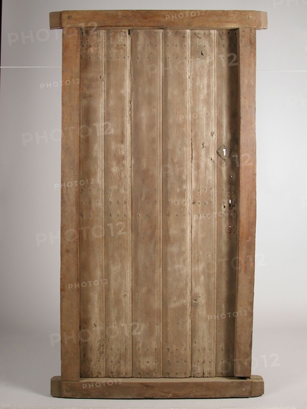 Room door in frame, door frame building part wood oak, sawn planed Room door hinged with three shelves and four cleats