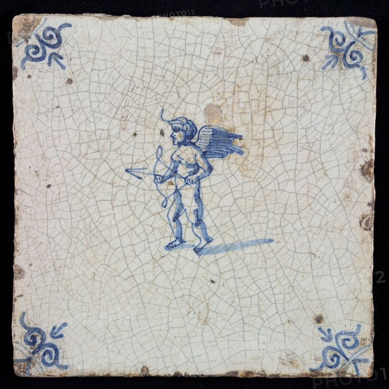 White tile with blue cupid with bow and arrow; corner pattern ox head, wall tile tile sculpture ceramic earthenware glaze, baked