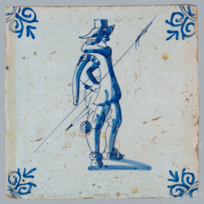 White tile with blue warrior with spear; corner pattern ox head, two shades of blue, wall tile tile sculpture ceramic