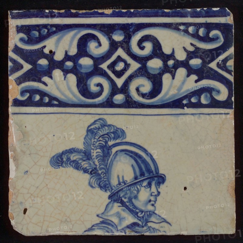 Tile of tableau with blue decorated border and helmeted head of soldier, tile picture footage fragment ceramic pottery glaze
