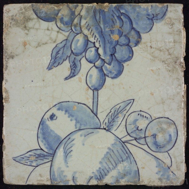 Tile of chimney pilaster, blue on white, part of up and down continuous representation with fruits, including grapes, chimney