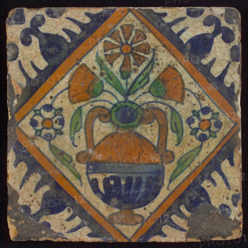 Tile, orange, brown, green, and blue on white, flowerpot in square, corner pattern palmet, wall tile tile sculpture ceramic