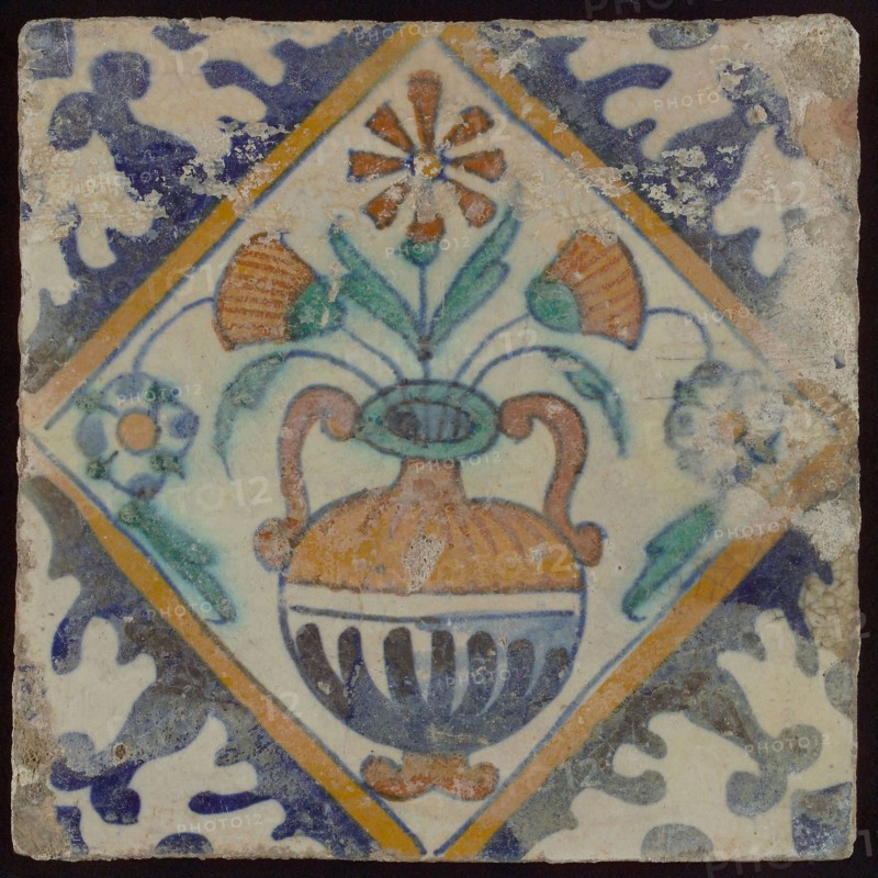 Tile, orange, brown, green, and blue on white, flowerpot in square, corner pattern palmet, wall tile tile sculpture ceramic