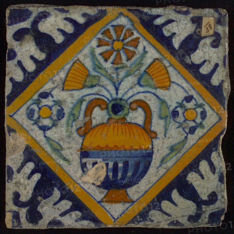 Tile, orange, brown, green, and blue on white, flowerpot in square, corner pattern palm, right side bevelled, wall tile
