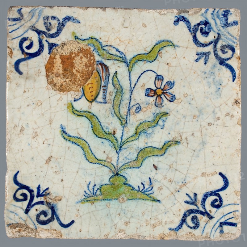 Tile, flower on spot in yellow, brown, green and blue on white, corner motif of ox-head, wall tile tile sculpture ceramic