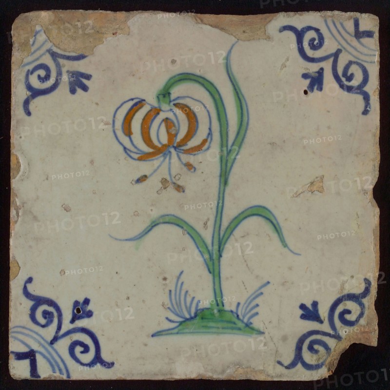 Tile, flower on ground in orange, green and blue on white, corner motif oxen head, wall tile tile sculpture ceramic earthenware