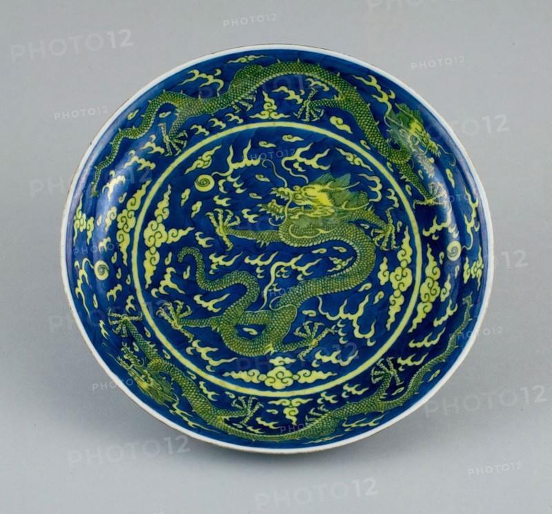Dish with Dragons amid Clouds, Chasing Flaming Pearls, Qing dynasty (1644–1911), Qianlong reign mark and period (1736–1795), China, Porcelain painted in underglaze blue and overglaze yellow enamel, H. 4.3 cm (1 11/16 in.), diam. 25.3 cm (10 in.)