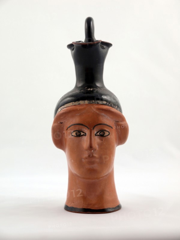 Oinochoe (Pitcher) in the Shape of a Female Head, about 450 BC, Greek, Athens, Attributed to the Canessa Class, Athens, terracotta, decorated in the red-figure technique, 14 × 6.7 × 8.9 cm (5 1/2 × 2 5/8 × 3 1/2 in.)