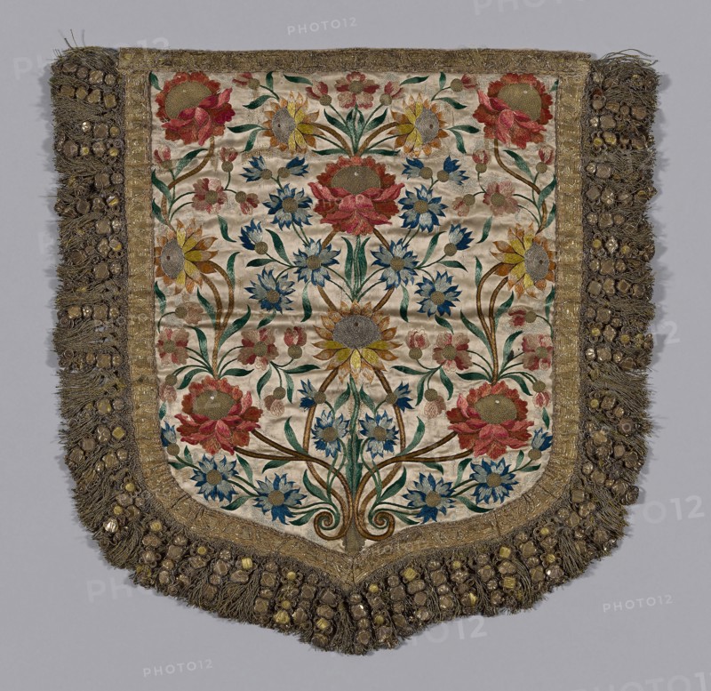 Hood of a Cope, 19th century, Spain, Silk in satin weave, lining is recent, braid in pattern in gilt metal and yellow silk floss, fringe of yellow silk wrapped with gilt metal with ornaments made of thin gauge metal in various shapes, embossed (brass color) over cardboard shapes padded with yellow silk floss, with edges formed of spiral gilt wires wired to gilt wrapped fiber cord, and additional ornaments of this construction and bowknots of wide "plate" wrapped around paper (?) core. Frisé holds ornaments together, braid and gilt-wrapped fiber used in pairs and gilt cord knotted in pattern hold groups of 4 ornaments in series, also: silk floss in color, silver frisé, stitches: satin (or float) long and short, stem, couching, outline, 60.6 x 61.3 cm (23 7/8 x 24 1/8 in.)