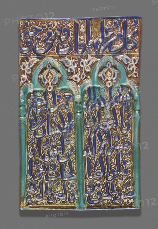Tile with Double-Arched Prayer Niche (Mihrab), Ilkhanid dynasty (1256–1353), 13th century, Iran, probably Kashan, Iran, Fritware with molded decoration, in-glaze painting in cobalt-blue and turquoise, and overglaze painting in luster, 50.8 × 31.9 cm (20 × 12 9/16 in.)