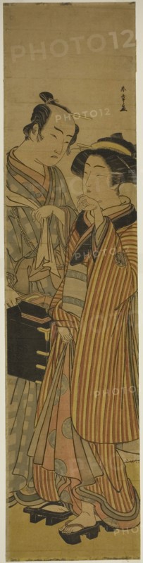 The Actors Segawa Kikunojo III as Okoma (right), and Arashi Sangoro III as the Hairdresser Obana Saizaburo (left), in the Play Koi Musume Mukashi Hachijo, Performed at the Nakamura Theater in the Third Month, 1776, c. 1776, Katsukawa Shunsho ?? ??, Japanese, 1726-1792, Japan, Color woodblock print, wide hashira-e, 69.3 x 16.5 cm (27 5/16 x 6 1/2 in.)