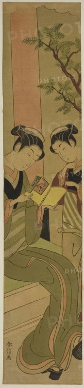 Osen of the Kagiya teahouse and an assistant reading a novelette, c. 1769/70, Suzuki Harunobu ?? ??, Japanese, 1725 (?)-1770, Japan, Color woodblock print, hashira-e, 25 x 5 in.