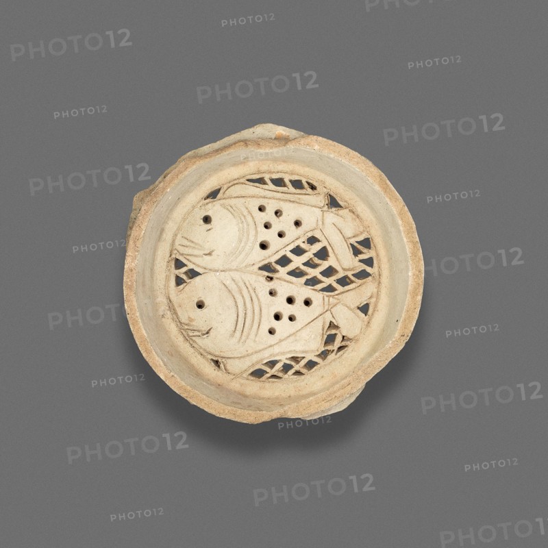 Clay filter with design of fish, Fatimid dynasty (969–1171), 11th–12th century, Egypt, Fustat, Masr al-`Atiqah, Earthenware, carved and punched, .75 × 7.3 cm (3/4 × 2 7/8 in.)
