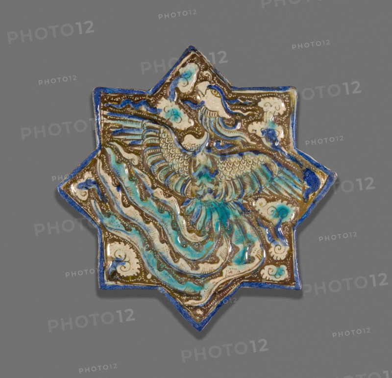 Star-Shaped Tile with Phoenix, Ilkhanid dynasty (1256–1353), late 13th century, Iran, possibly Takht-i Sulayman, Iran, Fritware with molded decoration, in-glaze painting in blue and turquoise, and overglaze painting in luster, 21.2 × 21.8 × 1.2 cm (8 5/16 × 8 9/16 × 1/2 in.)