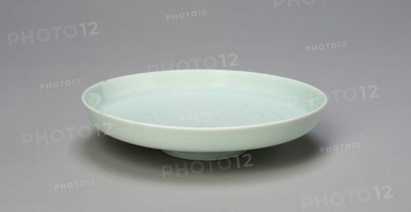 Dish with Auspicious Emblems: Clouds, Bats, Gourds, Plaintain, and Ruyi Scepter, Qing dynasty (1644–1911), Qianlong period (1736–1795), China, Porcelain with underglaze molded decoration, H. 2.5 cm (1 in.), diam. 10.9 cm (4 15/16 in.)