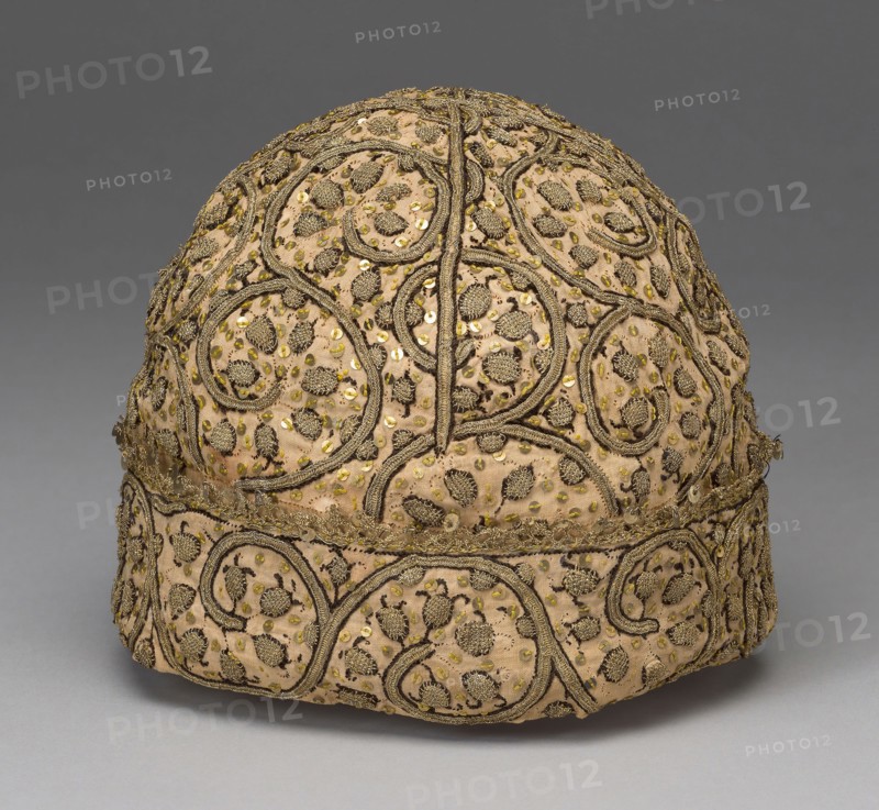 Man’s Cap, 1575/1600, England, Linen, plain weave, embroidered with silk, gilt-strip-wrapped silk, and metal paillettes in ladder and stem stitches, couching and buttonholed couching, edged with bobbin lace, 18 × 19 cm (7 × 7 1/2 in.)