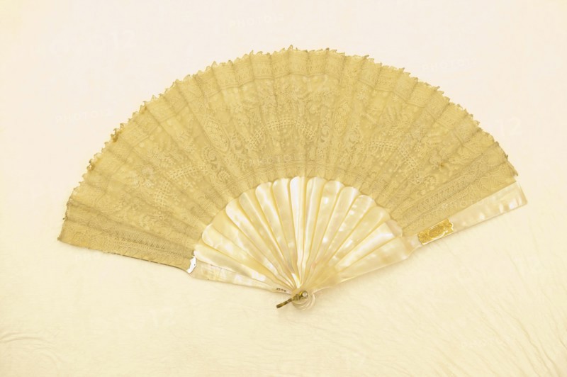 Fan, c. 1870, France, Etched mother-of-pearl sticks and guards, point de gaze mount, backed with gauze, rhinestone rivet, gilt loop, 24.1 cm (9 1/2 in.)