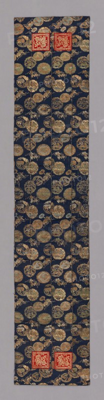 Ôhi (Stole), late Edo period (1789–1868), 1801/25, Japan, make of pieces of nishiki-kinran, silk compound weave, with ground of dark blue flecked pattern and circular motifs woven in colored silks and kinran, cut paper with gold foil., 145.8 x 29.9 cm (57 3/8 x 11 3/4 in.)