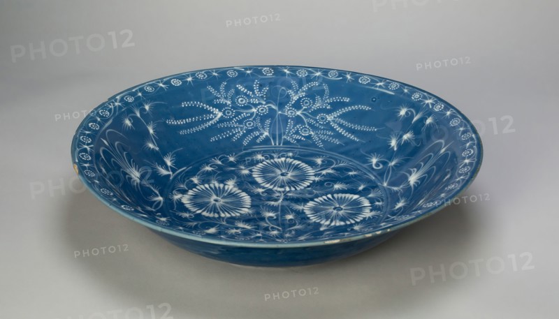 Dish with Chrysanthemums and Stylized Floral Scrolls, Ming dynasty (1368–1644), 15th century, China, Stoneware with white slip decoration on powder blue glaze, H. 8.9 cm (3 1/2 in.), diam. 40.5 cm (15 15/16 in.)