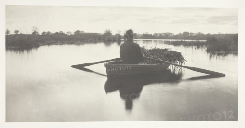 Rowing Home the Schoof-Stuff, 1886, Peter Henry Emerson, English, born Cuba, 1856–1936, England, Platinum print, pl. XXI from the album "Life and Landscape on the Norfolk Broads" (1886), edition of 200, 13.8 × 27.8 cm (image/paper), 28.6 × 40.8 cm (album page)