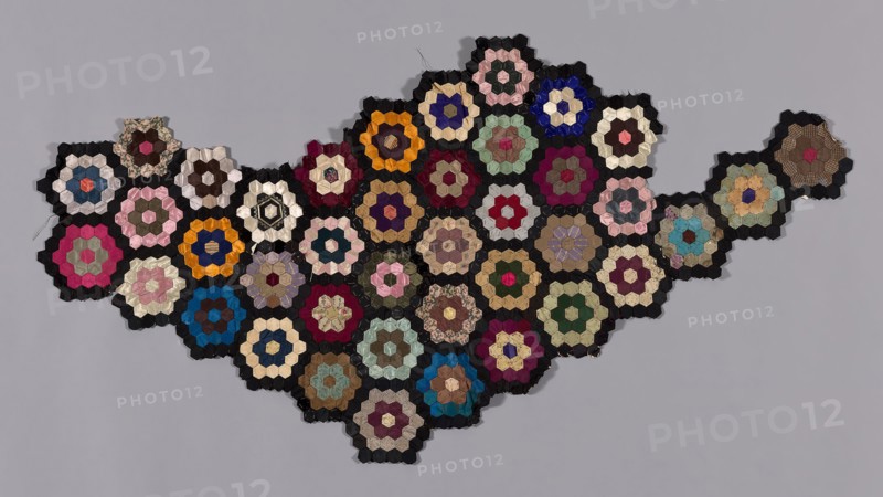 Fragment from Bedcover (Mosaic or Honeycomb Quilt), 1876, United States, Silk and cotton, plain, twill, and satin weaves, some with patterning warps, some with patterning or brocading wefts, some self-patterned, and some with cut solid velvet, some warp painted (chiné), pieced over paper, 66 x 116.9 cm (26 x 46 in.)