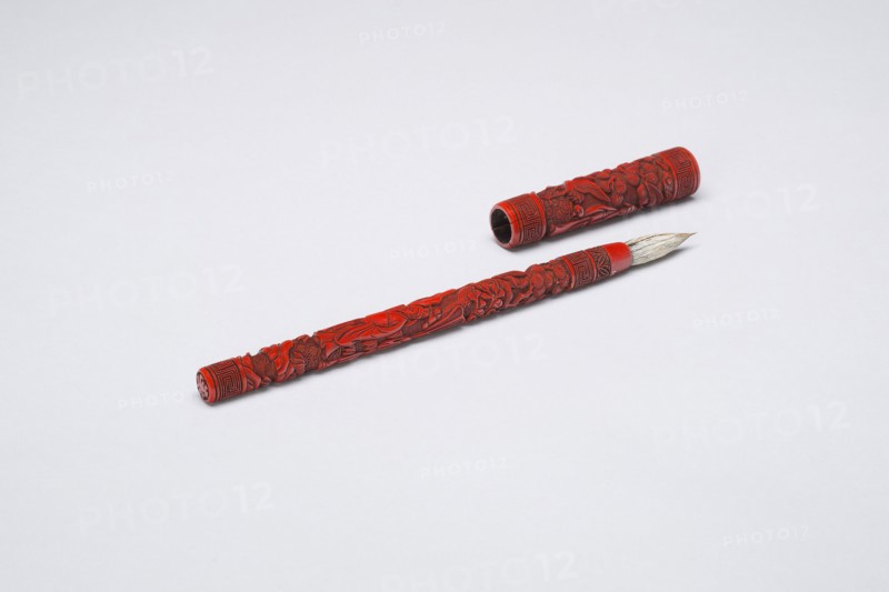 Brush and Cover with Figures in a Garden, Late Ming (1368–1644) or early Qing dynasty (1644–1911), 17th century, China, Cinnabar lacquer and animal hair with carved decoration, L. 22.7 cm (8 15/16 in.), diam. 1.9 cm (3/4 in.)