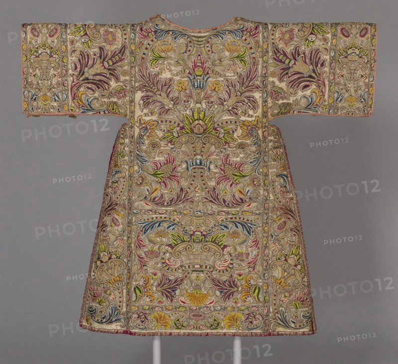Dalmatic, 17th century, Spain or Italy, Spain, Silk, plain weave with twill interlacings of secondary binding warps and silvered-metal wire facing wefts, underlaid with linen, plain weave, embroidered with silk, gilt-metal purl and gilt-metal-strip-wrapped silk in brick, overcast and split stitches, laid work, couching, padded couching and French knots, edged with silk and gilt- and silvered-metal-strip-wrapped silk, plain weave with supplementary patterning wefts and extended ground weft cut fringe, 118.2 x 127.7 cm (46 1/2 x 50 1/4 in.)