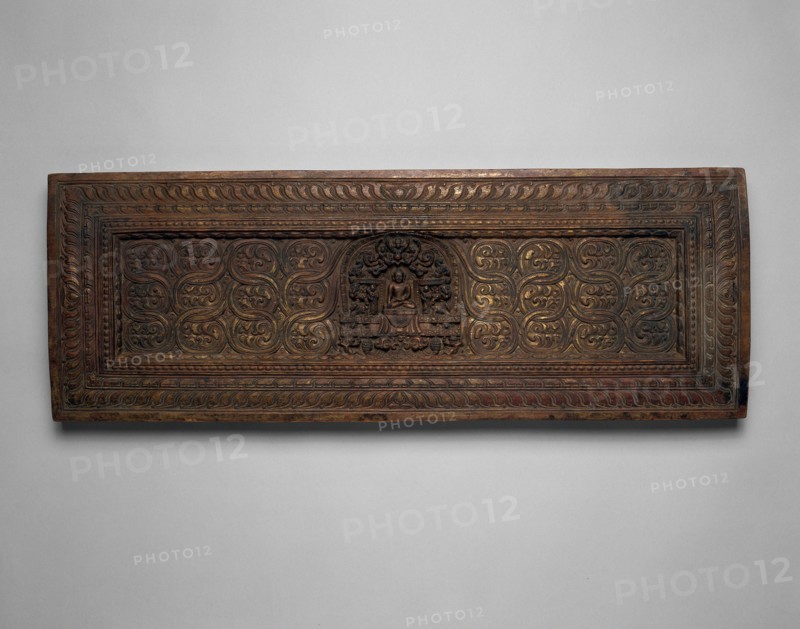 Manuscript Cover with Enshrined Sakyamuni Buddha with Hand in Earth Touching (Bhumisparsha) Mudra, 15th century, Tibet, Central Tibet, Tibet, Wood with traces of gilding, 25.2 x 70.8 x 3.9 cm (9 15/16 x 27 7/8 x 1 1/2 in.)