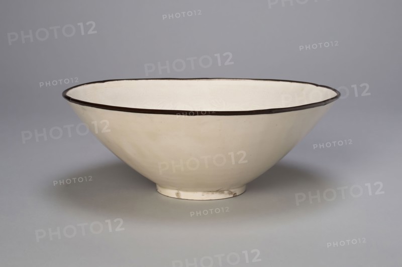 Bowl with Boys Playing amid Peony Blossoms, Jin dynasty (1115–1234), 12th century, China, Ding ware, porcelain with underglaze molded decoration, metal rim, H. 6.4 cm (2 1/2 in.), diam. 21.0 cm (8 1/4 in.)