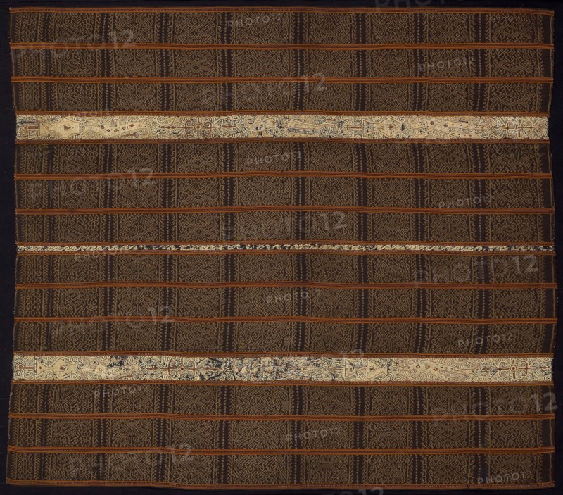 Woman’s Ceremonial Skirt (tapis), 19th century, Paminggir people, Indonesia, South Sumatra, Lampung, Indonesia, Two panels joined: stripes of cotton, warp resist dyed (warp ikat), plain weave with paired warps, cotton and silk, plain weave with supplementary brocading wefts: and stripes of cotton, plain weave embroidered with silk and gold-leaf-over-lacquered-paper-strip wrapped silk in back, chain, stem and surface satin stitches, laidwork and couching, 145.7 x 128.7 cm (57 3/8 x 50 5/8 in.)