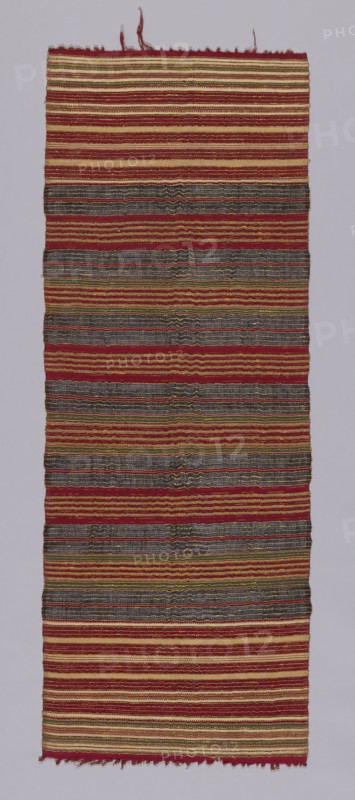Cermonial Textile, 19th century, Indonesia, Bali, Buleleng, Bali, Cotton, bast fiber (probably ramie), and gold-leaf-on-paper-strip-wrapped bast fiber (probably ramie) bands of plain weave, weft resist dyed (weft ikat) plain weave and weft-faced plain weave, knotted main warp fringe, 124.5 × 43.4 cm (49 × 17 1/8 in.)