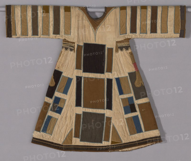 Tunic (Jibbeh), 1885/99, Mahdiyya State, Sudan, Sudan, Layers of cotton, plain weave, pieced and quilted, appliquéd with wool and wool and cotton plain weaves and wool twill weaves, embroidered with cotton in chain, cross, and a derivative of herringbone stitches, applied plied yarn edging, lined with cotton plain weaves, pieced, 93.7 x 116.8 cm (36 7/8 x 46 in.)