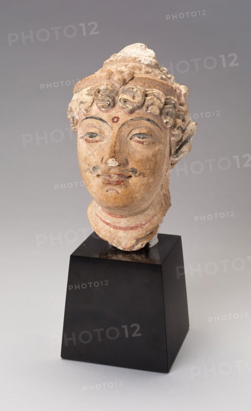 Head of a Bodhisattva, 3rd/5th century, Afghanistan or Pakistan, Ancient region of Gandhara, Gandhara, Stucco with red and black pigment, 14 × 8.5 × 10.2 cm (5 1/2 × 3 5/16 × 4 in.)